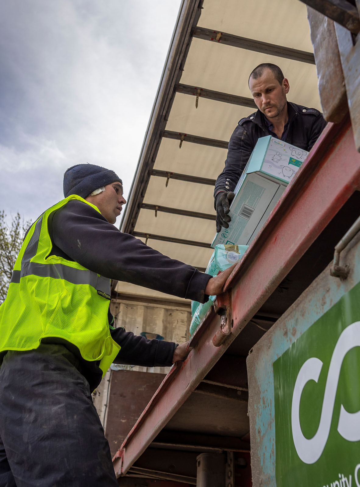 Two CORE team members unload supplies off of a truck in Ukraine.