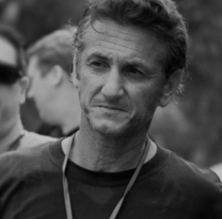 Sean Penn in a black and white photo in the field.