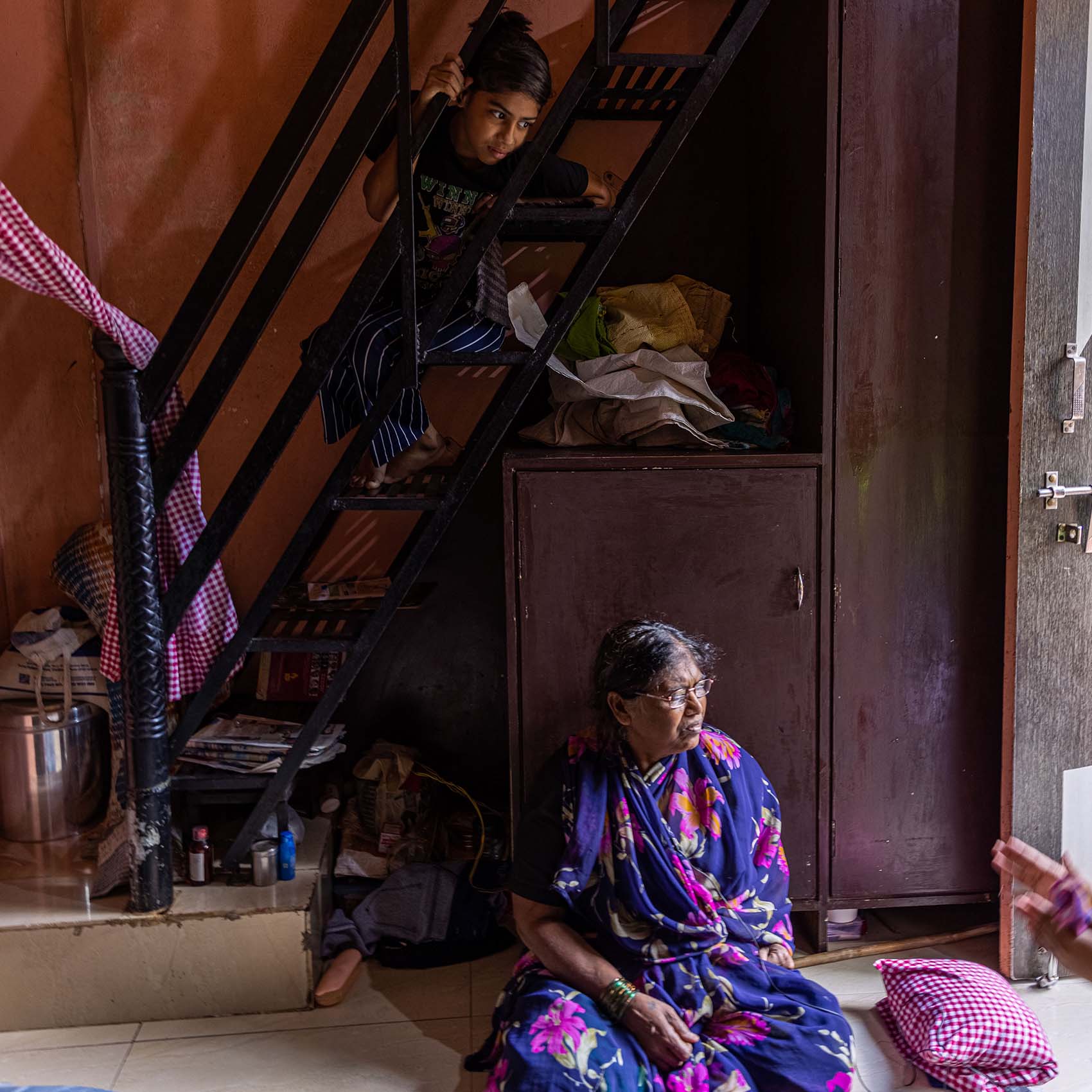 Ratan is sitting in her house in India near the stair. She is one of CORE's beneficiary during our food distribution in 2022.