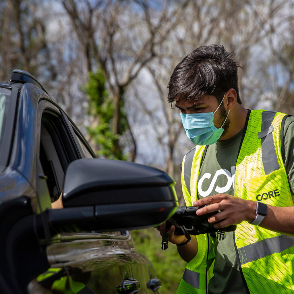 A CORE staff members talking to someone in their car at a COVID-19 testing site in Georgia.