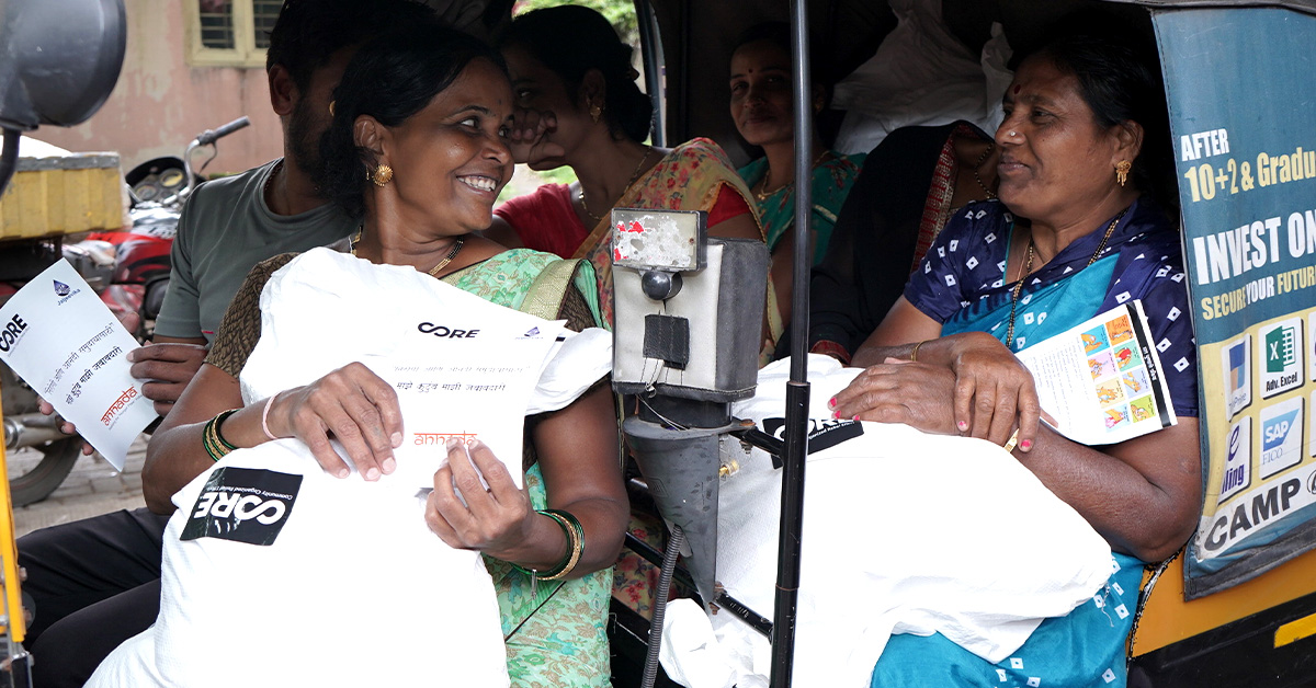 Food kit recipients pile into a moto-taxi to return home after a distribution in Vishrantwadi