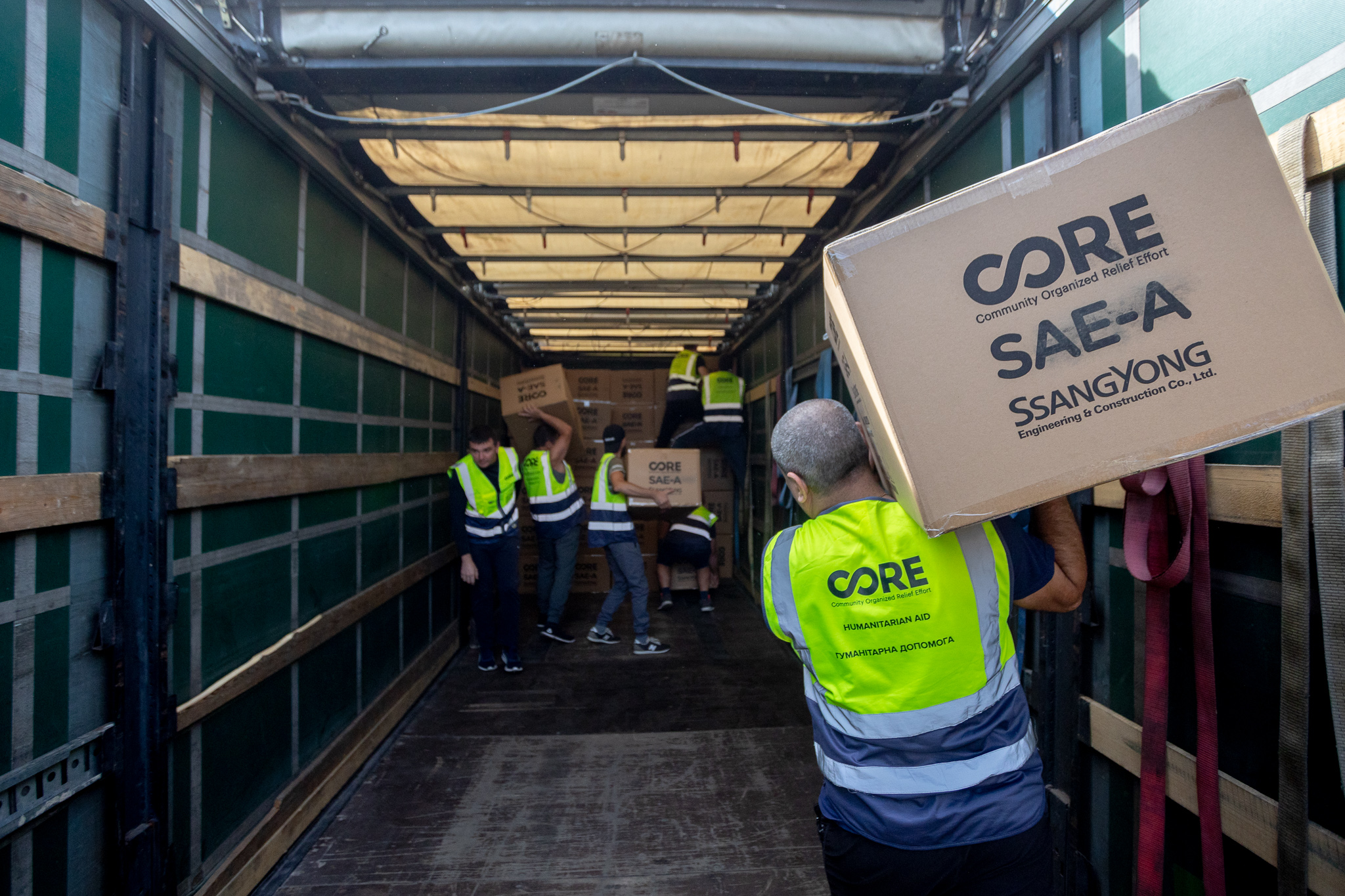 CORE team members unloading aid supplied in partnership with Sae-A and Ssangyong