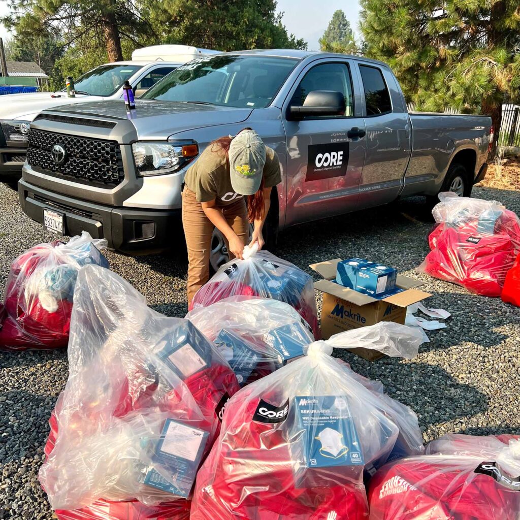 A CORE staff member assembles bags of supplies to distribute to community members.