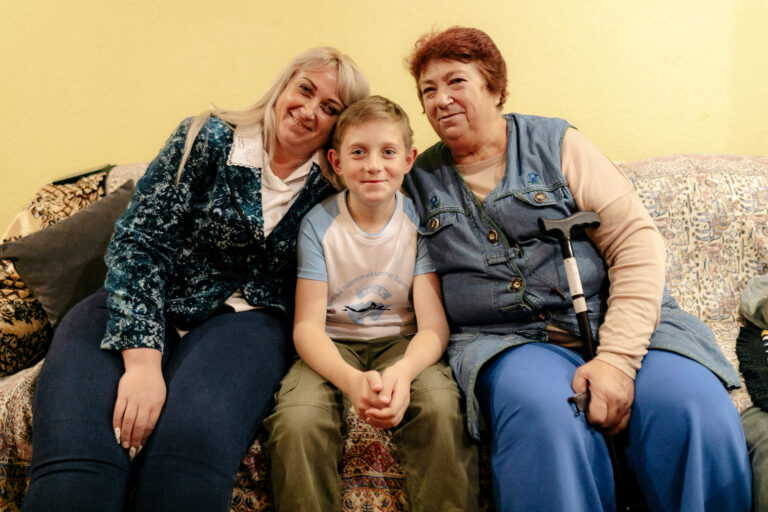 The Draka family poses for a photo inside of their new apartment after fleeing from front-line fighting.