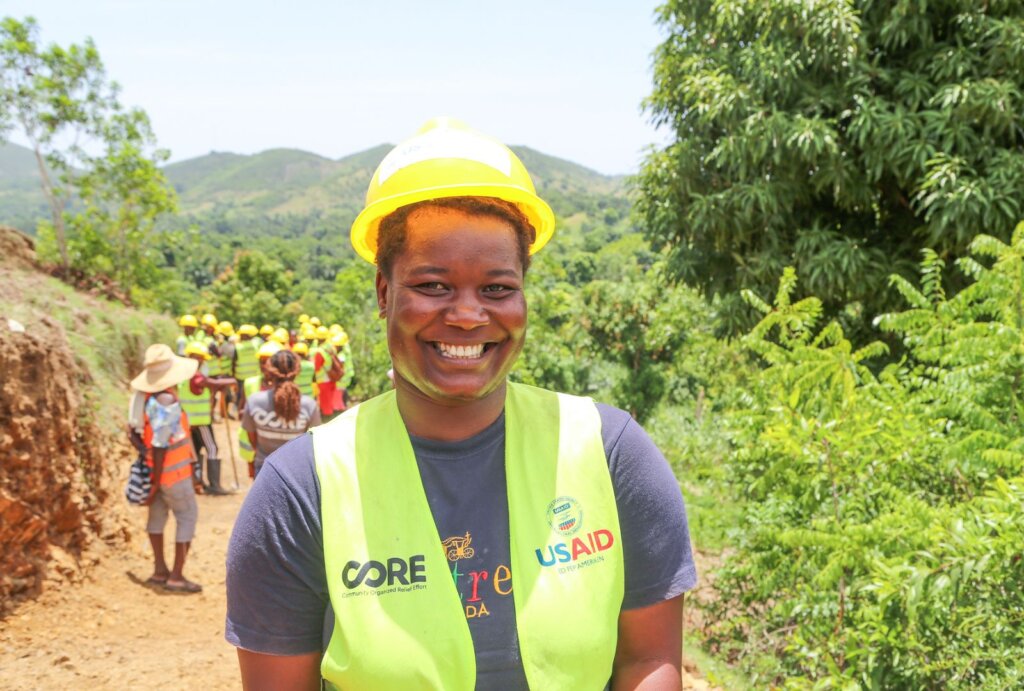 Marie-Flore, Haiti - headshot of a woman in hard hat and neon vest