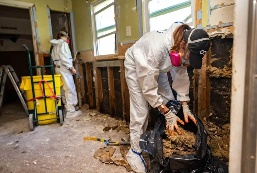 Staff working on a house in Texas performing critical mucking and gutting work.