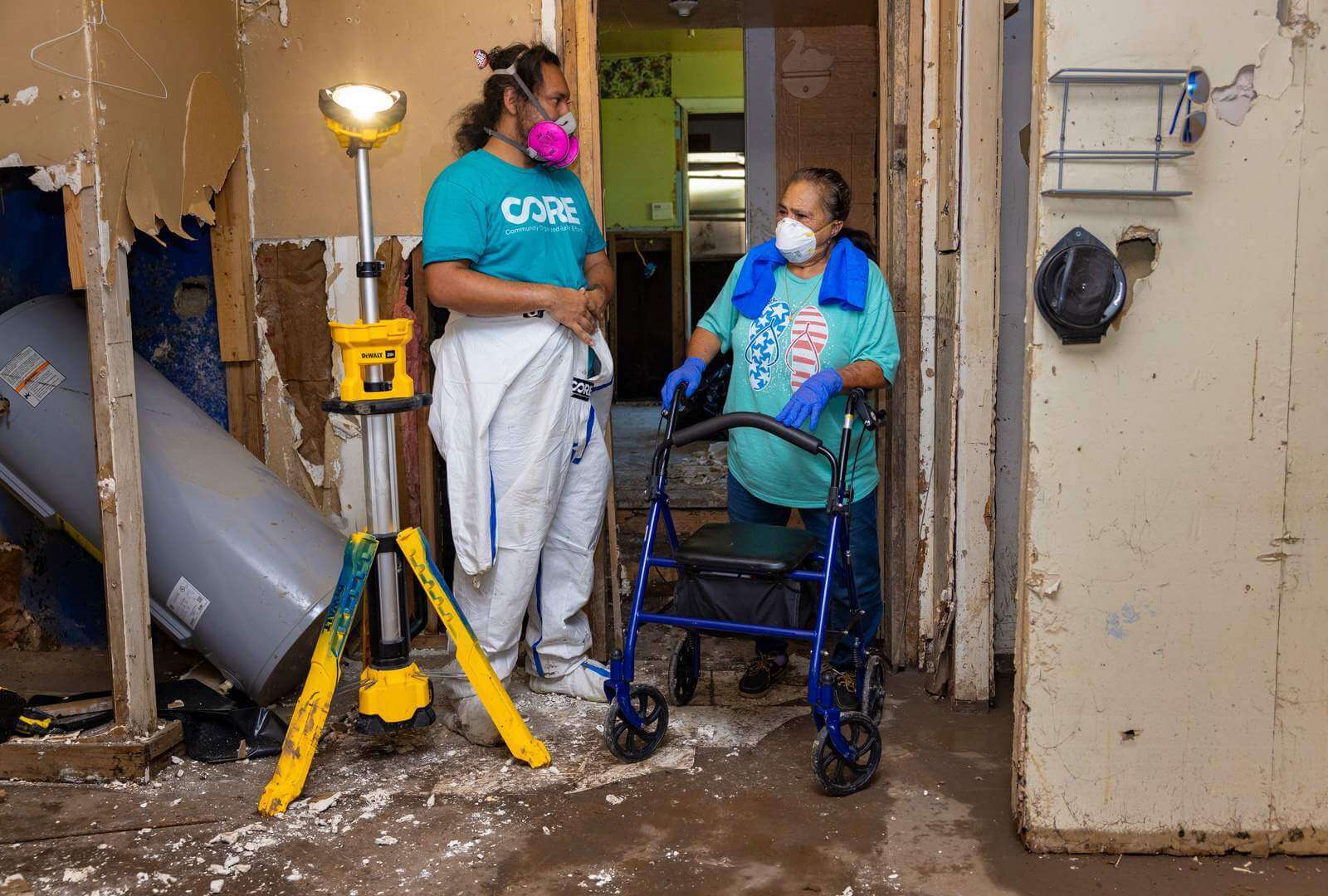 George Hernandez Mejia, CORE’s Humanitarian Response Director, walks Maria through the work being done in her home.