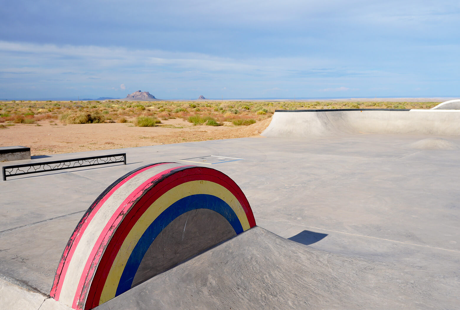 A photo of the Two Grey Hill skatepark that shows a rainbow rail and a few other features.