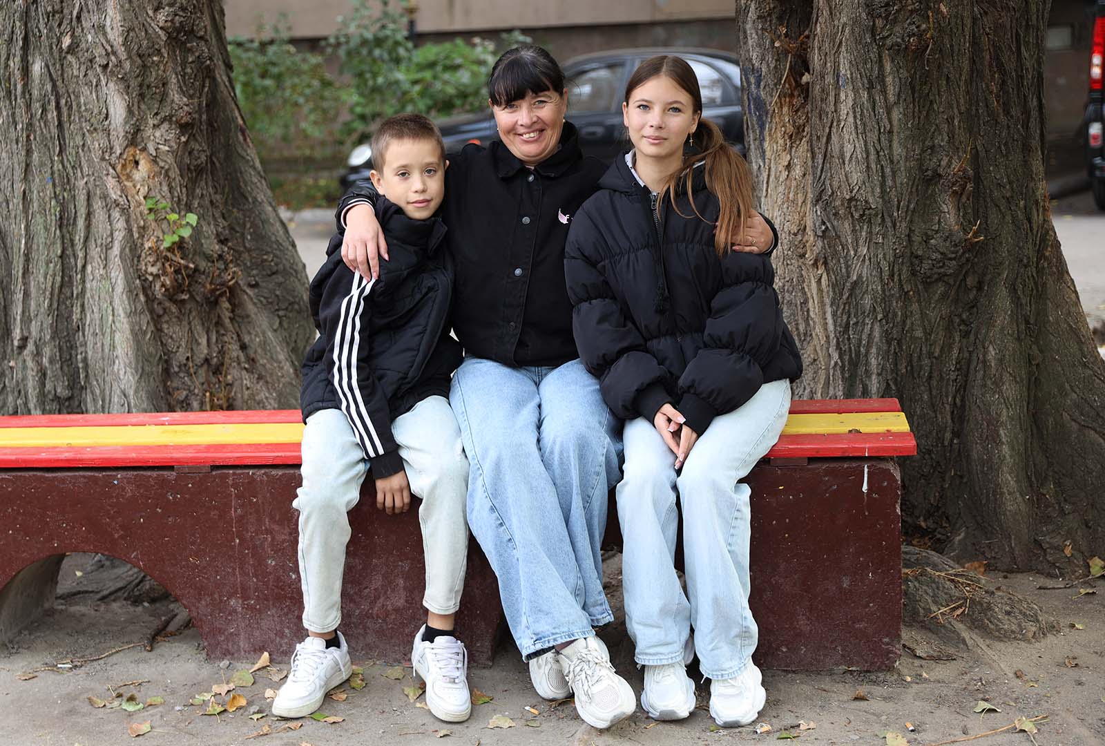 Tram driver student, Victoria, poses in a photo with two of her children.