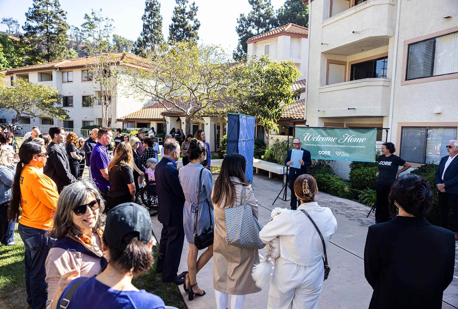 Glen from the Change Reaction speaks to a crowd of residents and guests.
