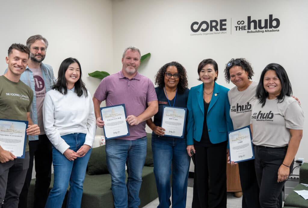 A group of people pose with Representive Chudy Chu at The Hub in Altadena.
