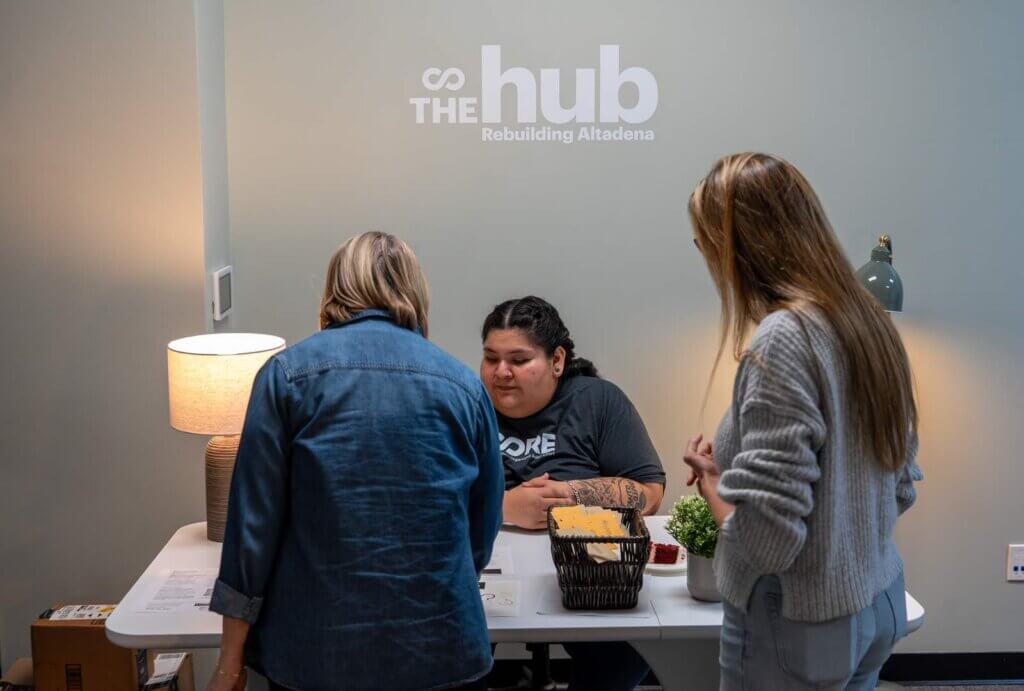 Two guests check in at The Hub's front desk.