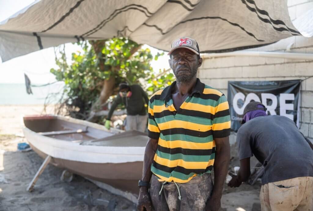 man standing in front of boat