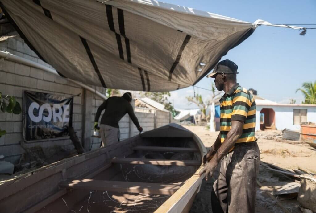 men fixing boat